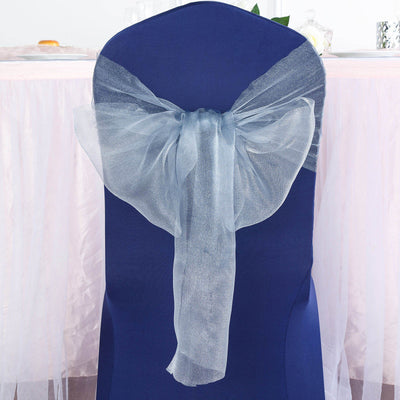 Blue chair cover with sheer silver bow, elegant party decor.