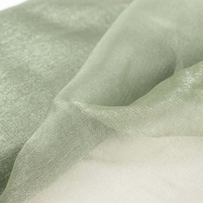 Soft green sheer fabric close-up, highlighting delicate texture and shimmer.