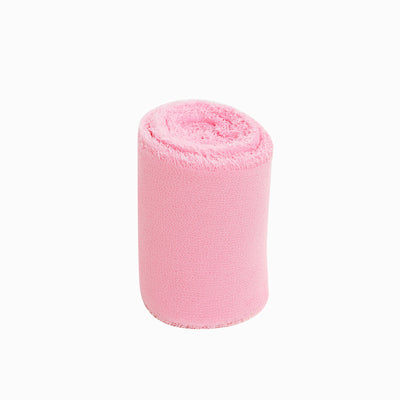 Pink rolled towel on white background