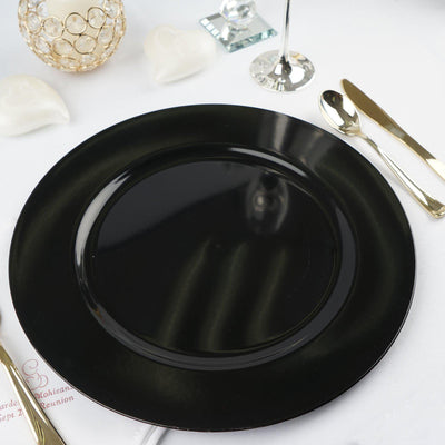 Black dinner plate on a white table setting with elegant utensils.
