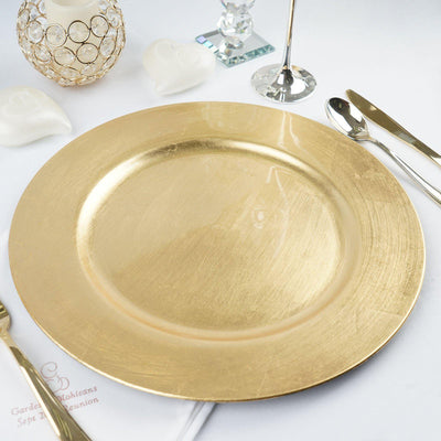 Gold charger plate on a table setting with elegant decor.
