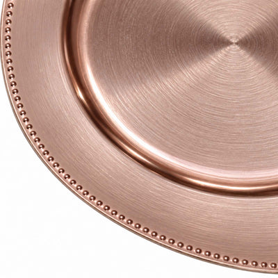 Copper hammered metal plate with beaded rim, close-up texture