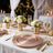 Elegant rose gold wedding table setting with white flowers and candles