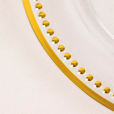 Clear glass plate with gold beaded rim detail.