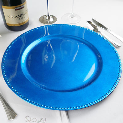 Blue charger plate with beaded rim on a table setting.