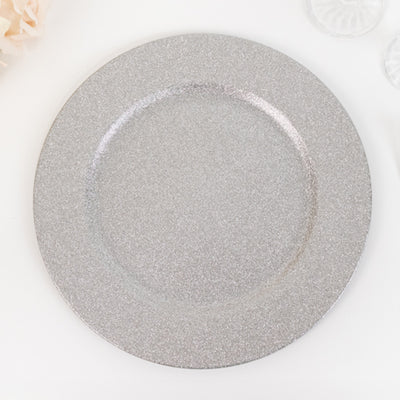 Silver glitter charger plate on a plain background