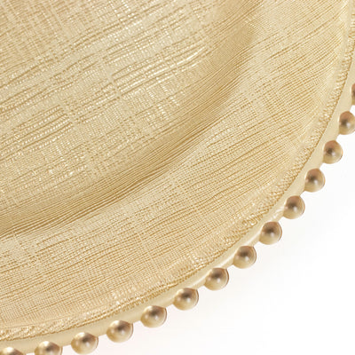 Elegant gold charger plate with textured finish and beaded rim.