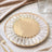 Elegant gold and crystal decorative plate with a mirrored center.