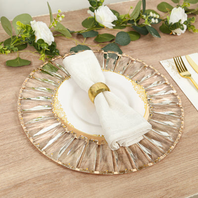 Elegant glass charger plate with gold accents and a white napkin.