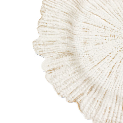 White decorative plate with textured design on a plain background