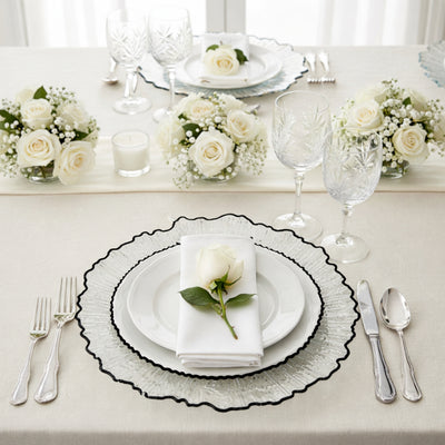 Elegant table setting with white roses and crystal glassware.