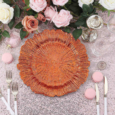Decorative orange plate surrounded by pink and white roses on a festive table setting.