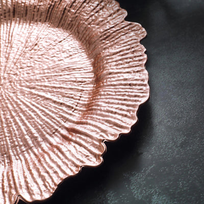 Textured rose gold serving platter with a scalloped edge.