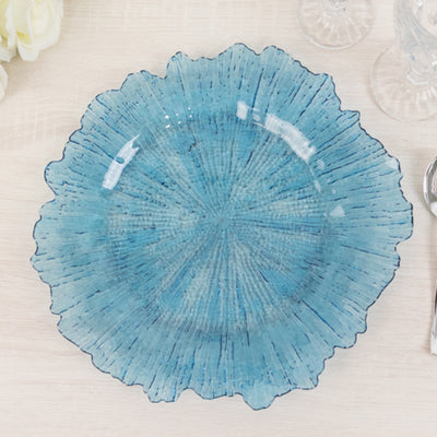 Blue decorative plate with textured design and ruffled edges.