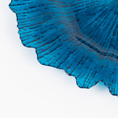 Blue decorative plate with textured design on a white background.