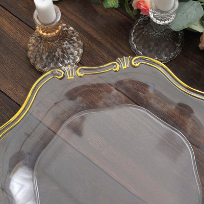 Decorative clear glass tray with gold accents on a wooden surface.