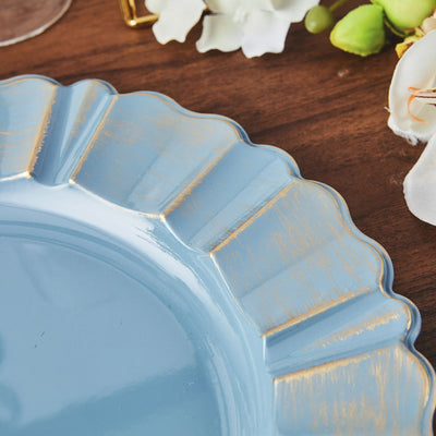 Blue decorative plate with gold accents on a wooden table.