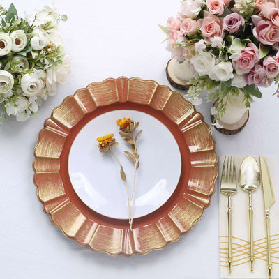 Elegant gold-rimmed plate with flowers and cutlery, styled with floral arrangements.