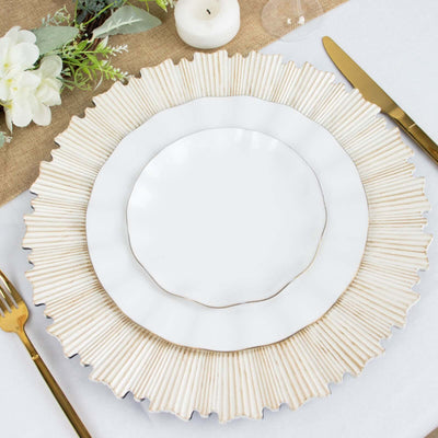 Elegant layered dinner plates with a decorative charger on a table setting.