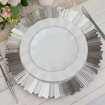 Silver and white decorative charger plate on a rustic table setting.