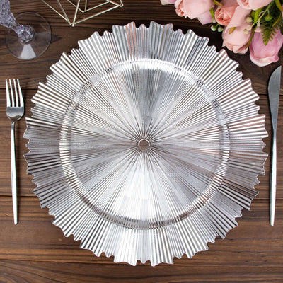 Silver decorative charger plate on a wooden table setting.