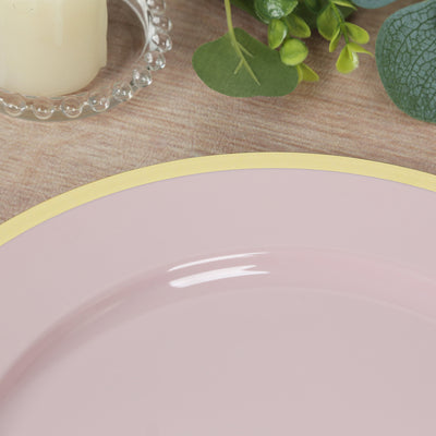 Pink plate with a yellow rim on a wooden surface surrounded by greenery.
