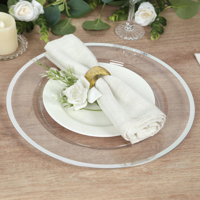 Elegant table setting with a clear charger plate, white dish, and decorative napkin.