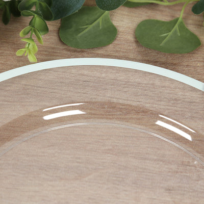 Clear glass plate on wooden surface with greenery