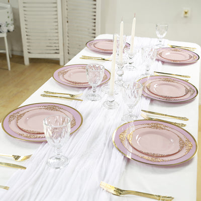 Elegant pink and gold dinnerware set arranged on a festive table setting.
