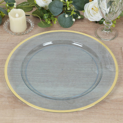 Elegant gray plate with gold rim on a wooden table setting.