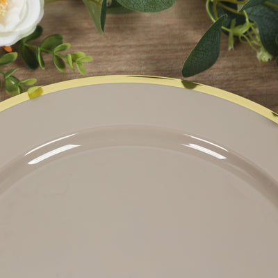 Beige plate with a gold rim on a wooden surface.