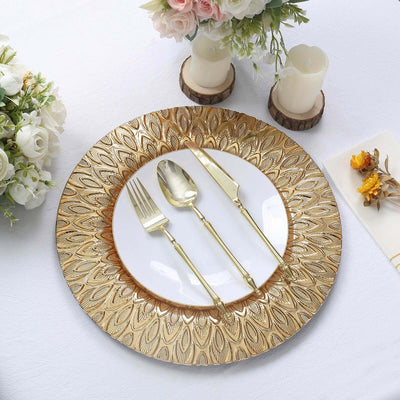 Elegant gold and white dinner plate set with cutlery on a table.