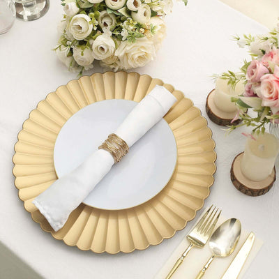 Elegant gold charger plate with white napkin and floral centerpiece on a dining table.