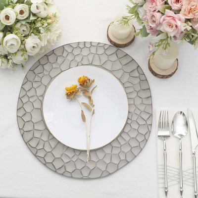 Elegant table setting with a decorative plate and floral accents.