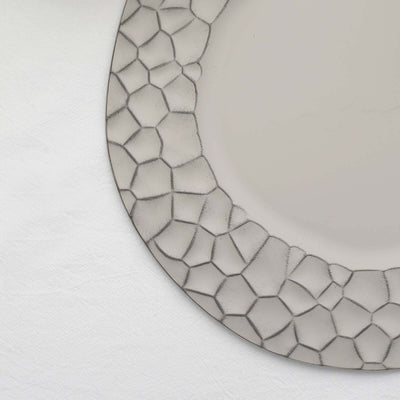 Decorative plate with a textured hexagonal border on a white background