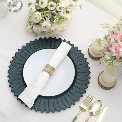 Elegant table setting with a green plate, white napkin, and floral centerpiece.
