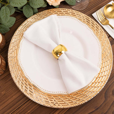 Elegant table setting with gold-rimmed plate and white napkin.