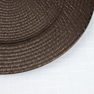 Brown woven placemat on a textured surface.