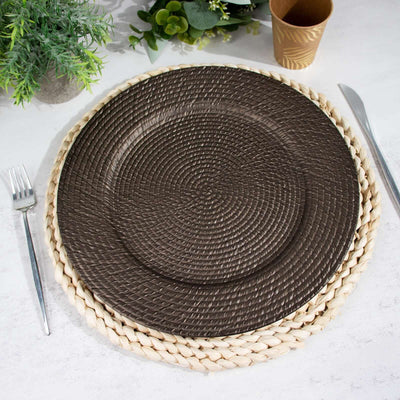 Round woven brown placemat on a dining table setting.