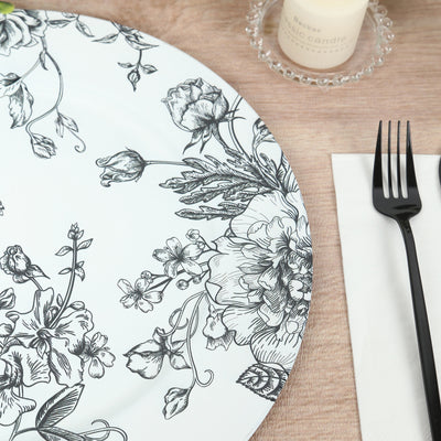 Floral patterned plate on a wooden table with fork and napkin.