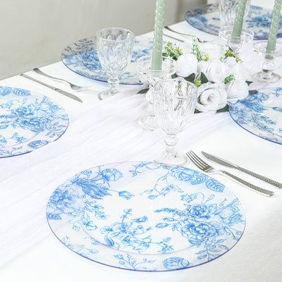 Elegant blue floral dinner plates set on a stylish table with crystal glassware.