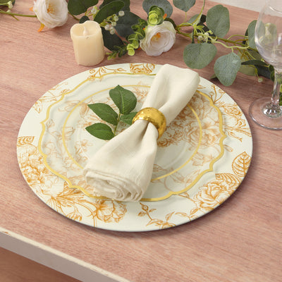 Elegant floral dinner plate with napkin and gold ring on a wooden table.