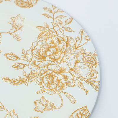 Floral-patterned ceramic plate with gold accents on a white background