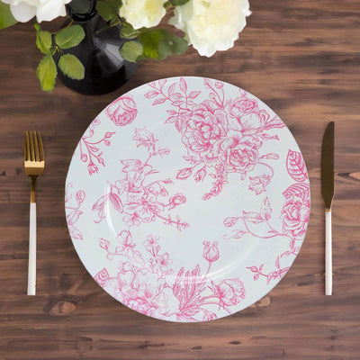 Floral-patterned plate on a wooden table with gold utensils.