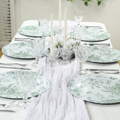 Elegant table setting with floral plates and crystal glassware.