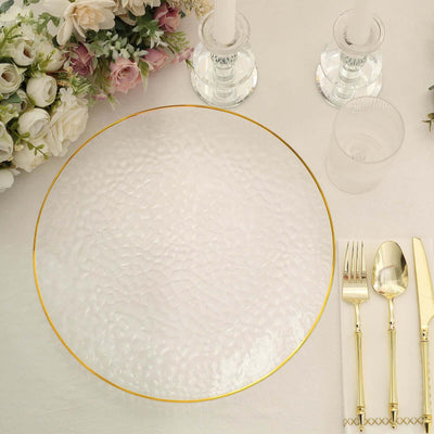 Elegant textured glass plate with gold rim on a dining table setting.