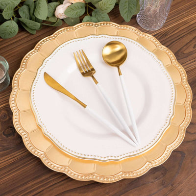 Elegant golden cutlery set on a decorative plate against a wooden table.
