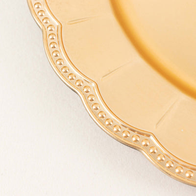 Gold decorative plate with intricate beaded edge detail.
