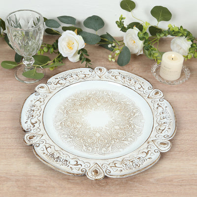 Decorative white plate with intricate floral design and carved edges.