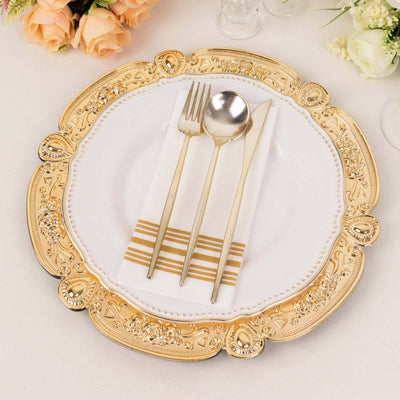 Elegant gold-accented plate set with cutlery and napkin on a table.